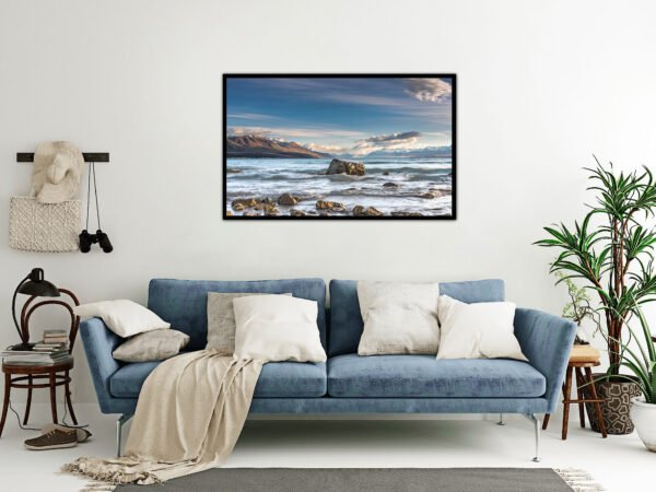 Cosy living room with sea landscape artwork.