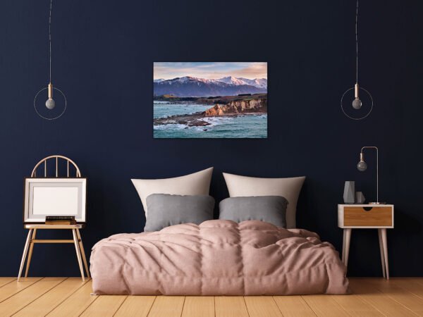 Modern bedroom with mountain lake artwork.