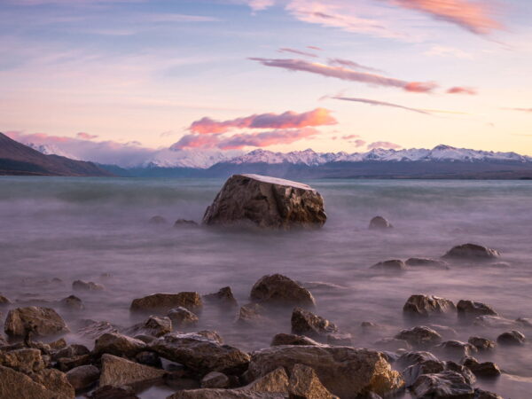 Rocky shore at sunset with pink clouds
