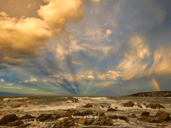 Dramatic seascape with rainbow and stormy clouds