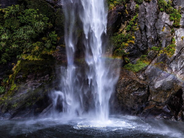 Milford Sound waterfall with a rainbow