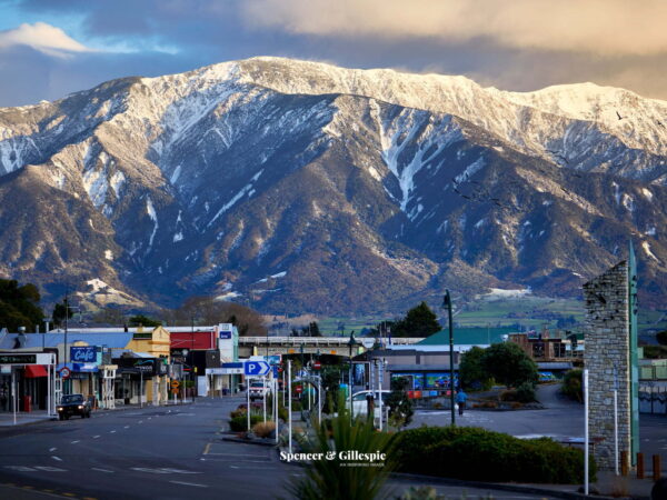Kaikoura town with snowy mountains in background.