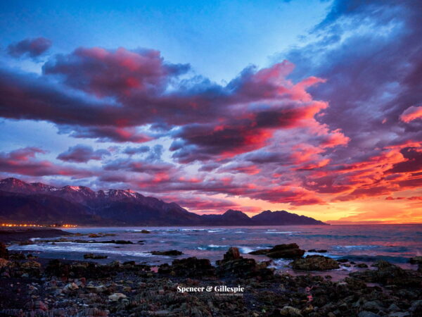 Kaikoura coast stunning sunrise over South Island mountains.
