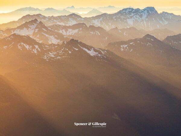 Sunset over snowy mountain range in New Zealand