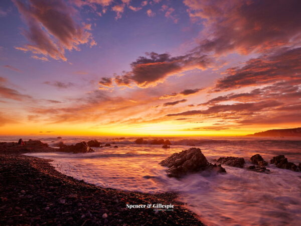 Sunrise over New Zealand rocky beach