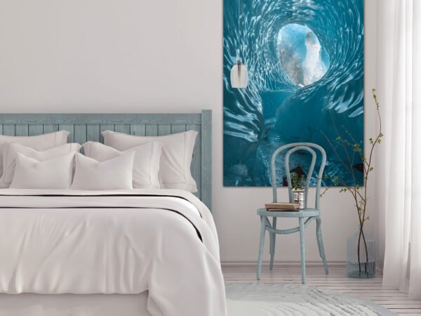 Cosy bedroom with blue accents and artwork.