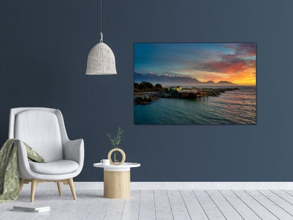 Modern living room with ocean view artwork.