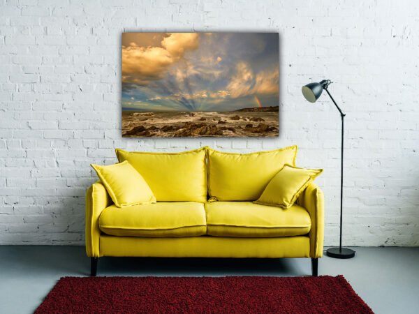 Yellow sofa with coastal artwork on wall