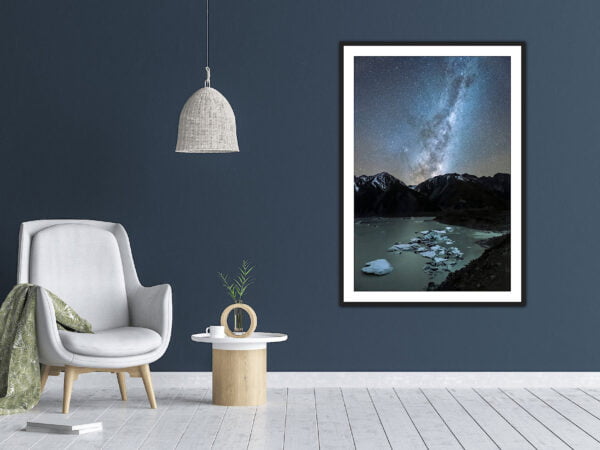 Modern lounge with starry wall art and grey chair.