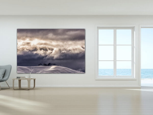 Modern room with ocean view and mountain painting.