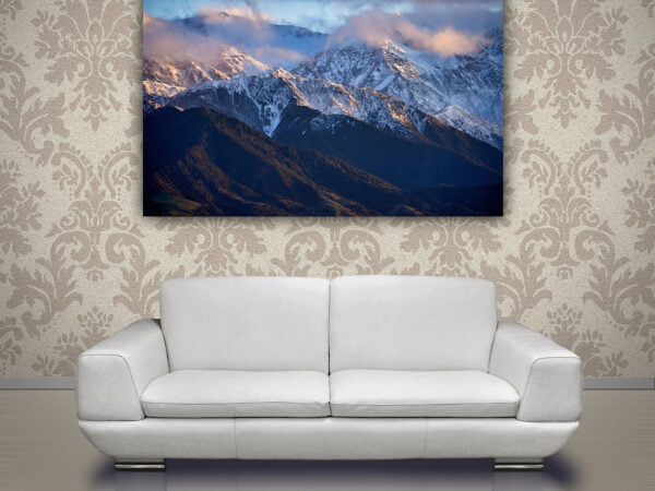 Mountain photo above grey sofa in living room.