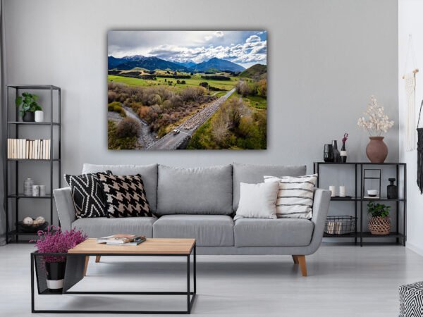 Modern living room with landscape artwork.