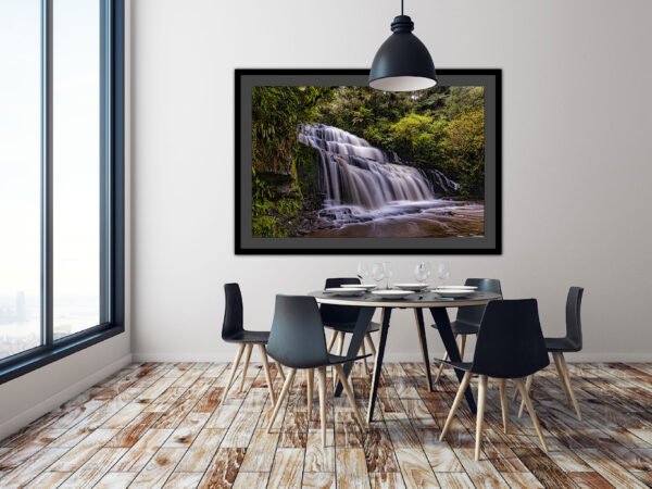 Dining room with waterfall artwork.