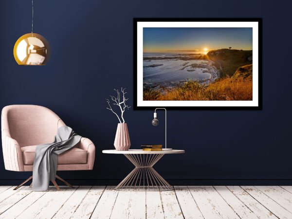 Modern lounge, framed seascape art, navy walls.