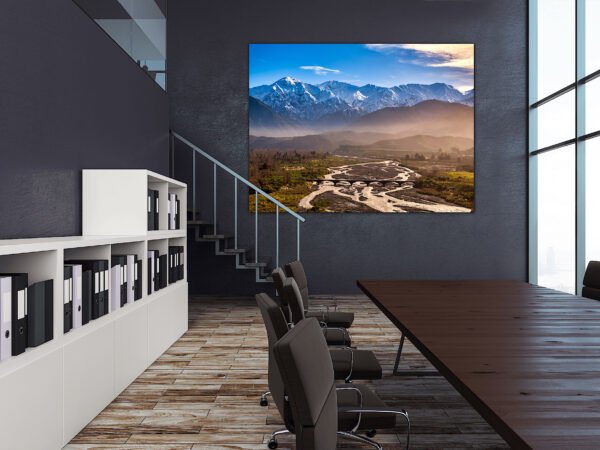 Modern office with mountain landscape painting.