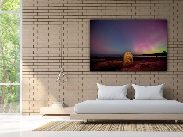 Modern bedroom with nature artwork and large window view.