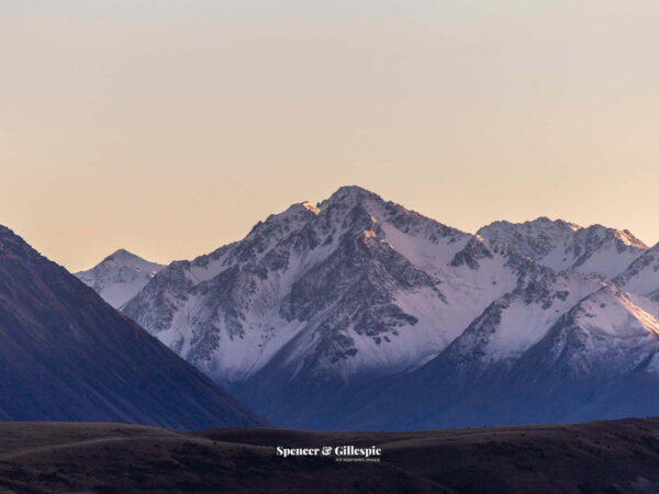 Snow-capped New Zealand mountains at sunset