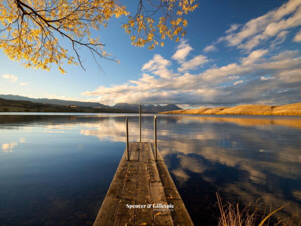 Dock overlooking tranquil lake and mountains