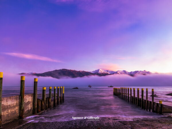Kaikoura wharf foggy ocean with mountain sunset