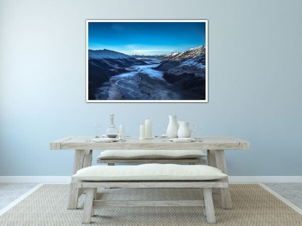 Dining area with mountain landscape photo on wall