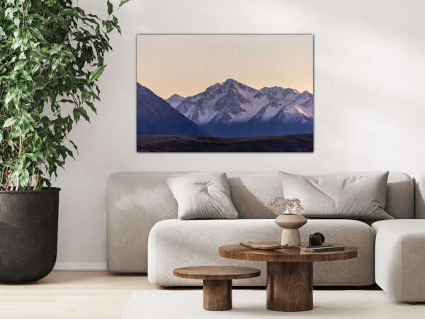 Modern lounge with mountain artwork and greenery