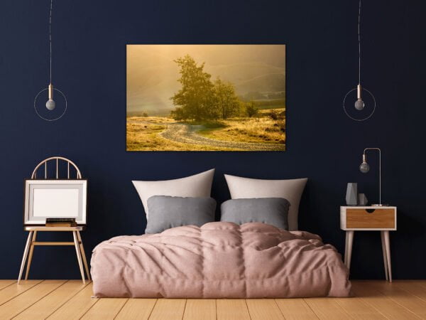 Bedroom with landscape photo on wall.